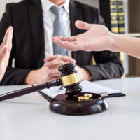 Young angry couple arguing telling their problems in the courthouse to getting divorced or premarital agreement in lawyers office, deciding on marriage divorce concept.