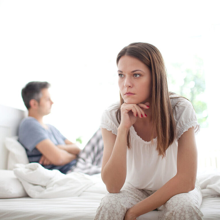 Young couple having relationship difficulties, shallow depth of field focus on foreground