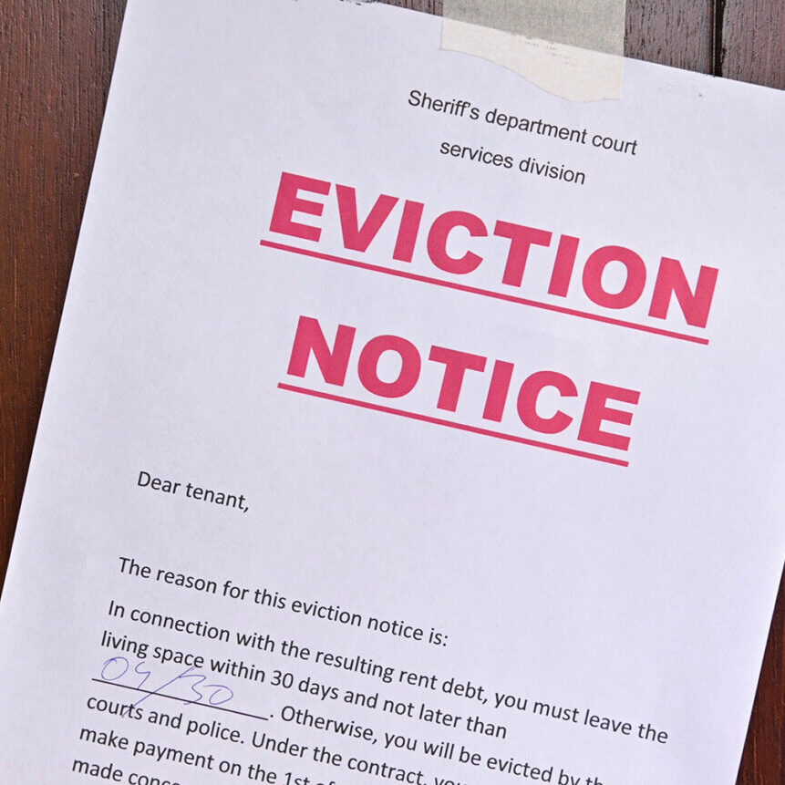 the notice of eviction of tenants hangs on the door of the house, front view